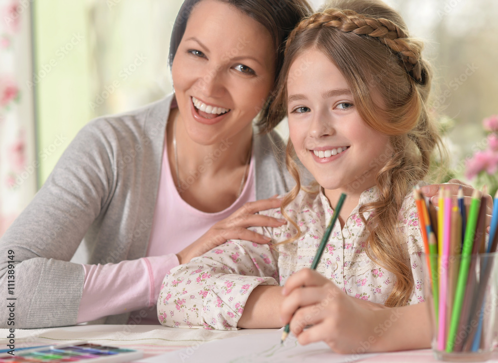 Smiling middle-aged woman and a young girl Smiling middle-aged woman and a young girl