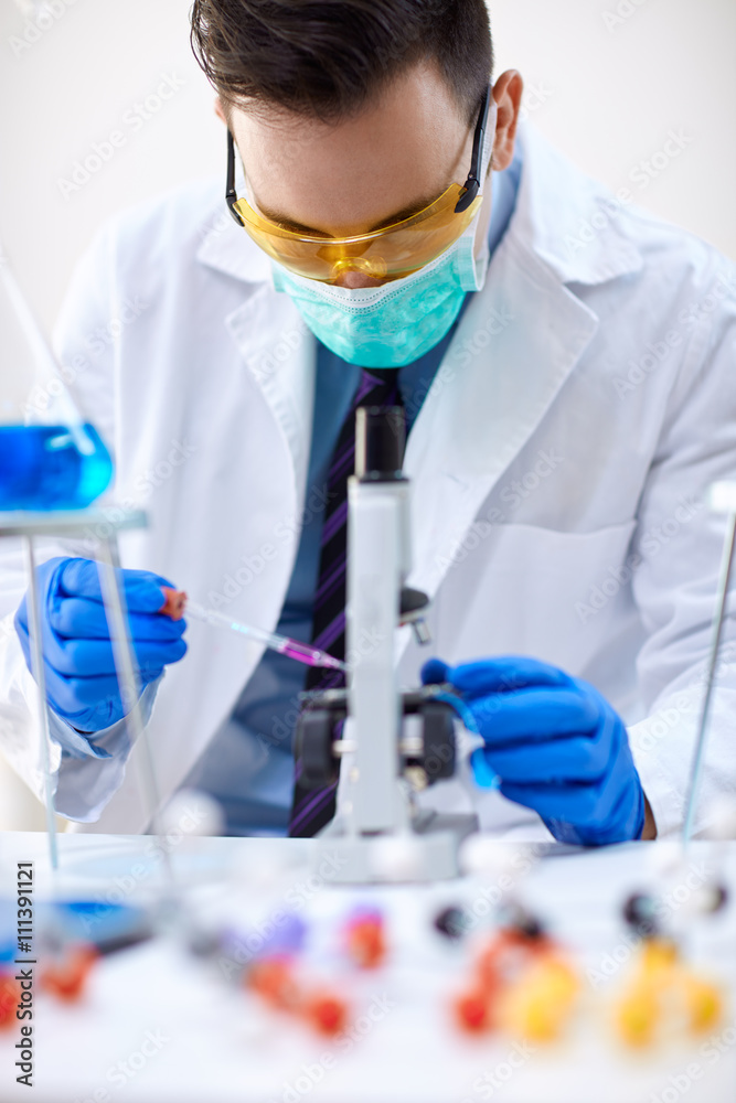 man scientist working in laboratory. man scientist working in laboratory.
