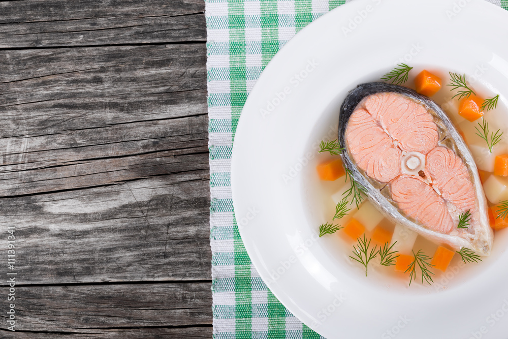 salmon soup with vegetables and dil, top view salmon soup with vegetables and dil, top view