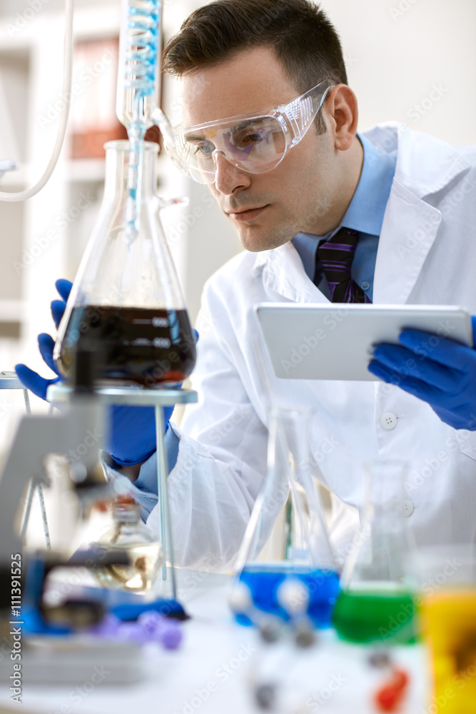 Fototapeta premium scientist analysis chemical experiment with tablet.