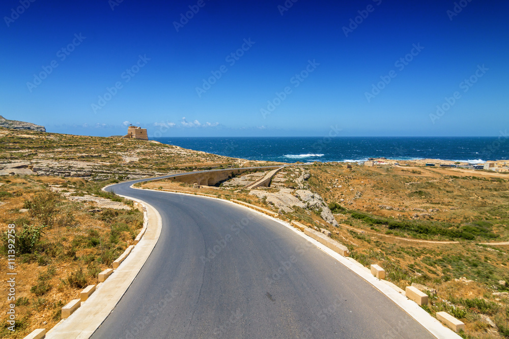 Sunny road to Dwejra bay in Gozo, Malta.