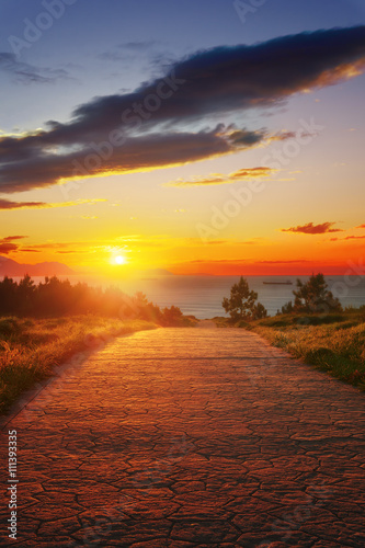 path near the sea at sunset