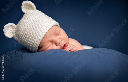 Three week old newborn baby boy sleeping