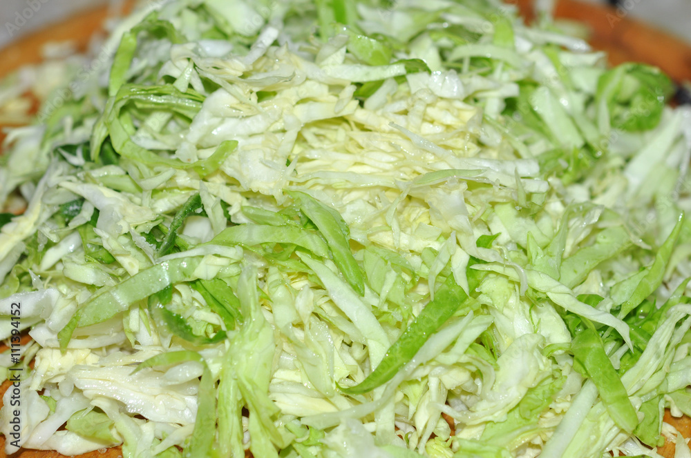 Cabbage chopped slice heap on wooden board Cabbage chopped slice heap on wooden board