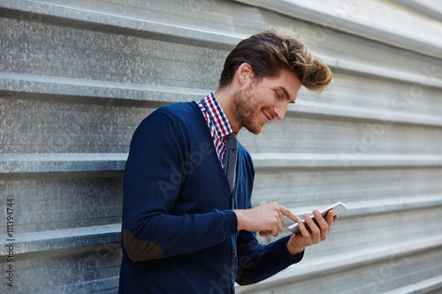 Young businessman texting smartphone phone
