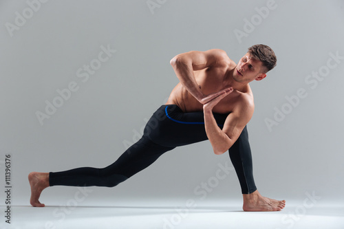 Young man doing yoga exercises