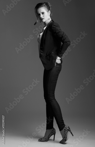 Portrait of modern elegant woman posing against grey background