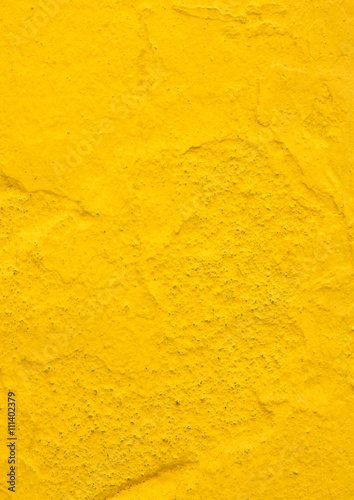 Texture of a rough yellow wall outdoors