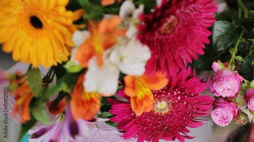 Close up of florist hands working with bouquet decoration.