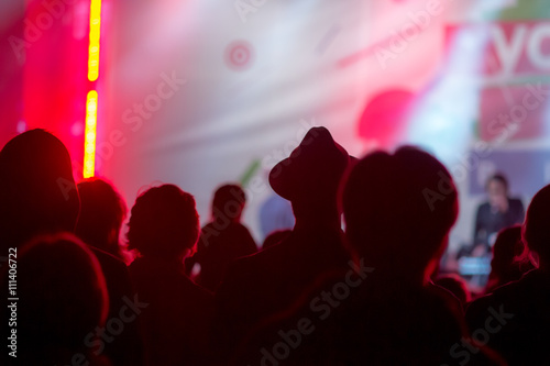 De-focused blurred concert crowd. silhouettes at night club