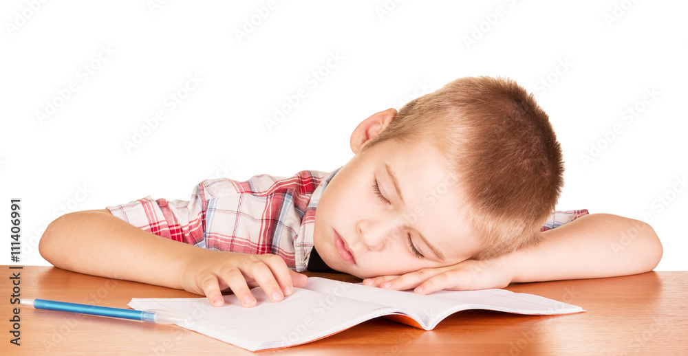 Boy asleep at his desk notebook isolated on white. Boy asleep at his desk notebook isolated on white.