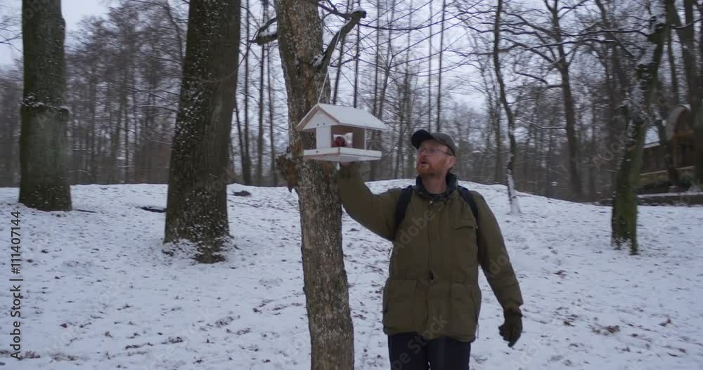 Man Comes to the Tree and Looks Into the Feeder Park Ground Covered With Snow Bare Trees Grey Sky Cloudy Winter Day Kiev Ukraine Man Comes to the Tree and Looks Into the Feeder Park Ground Covered With Snow Bare Trees Grey Sky Cloudy Winter Day Kiev Ukraine