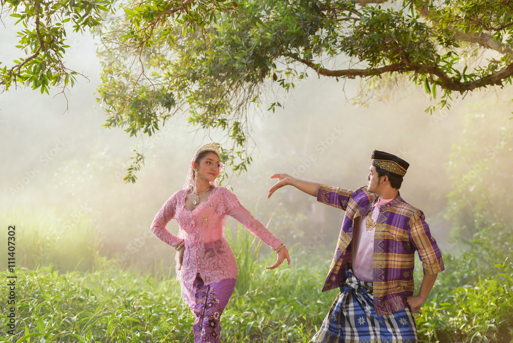 Asian Muslim man and woman wearing traditional dress