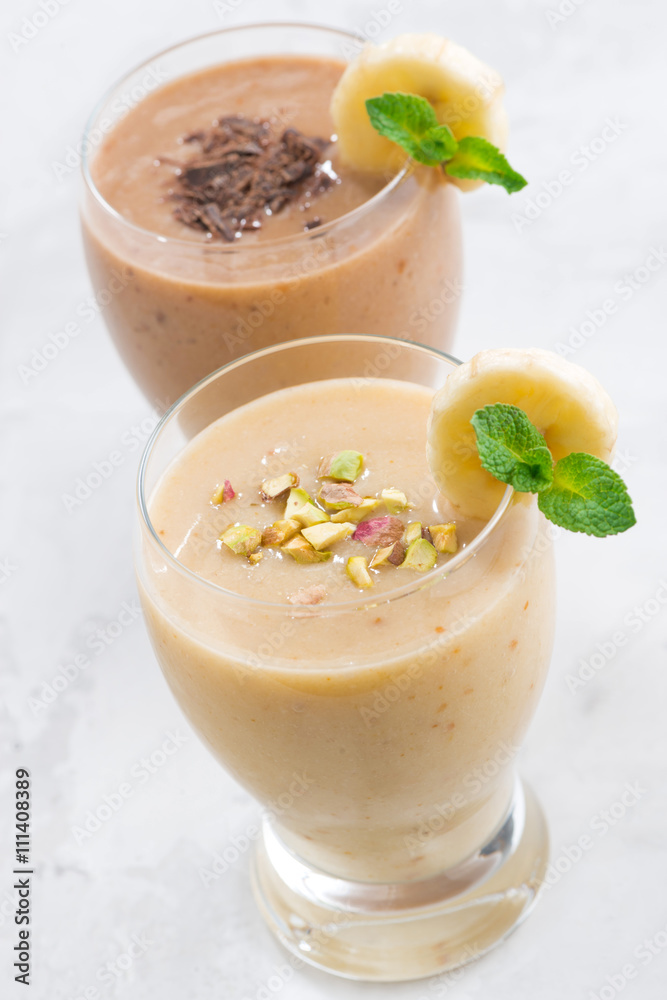 banana and chocolate smoothie in a glasses, vertical, top view banana and chocolate smoothie in a glasses, vertical, top view
