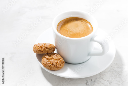 cup of espresso and almond cookies on a white table