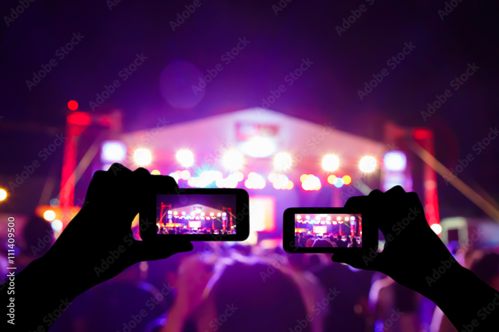 Take photo crowd in front of concert stage blurred