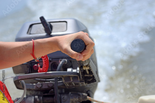 fisherman hand and boat engine