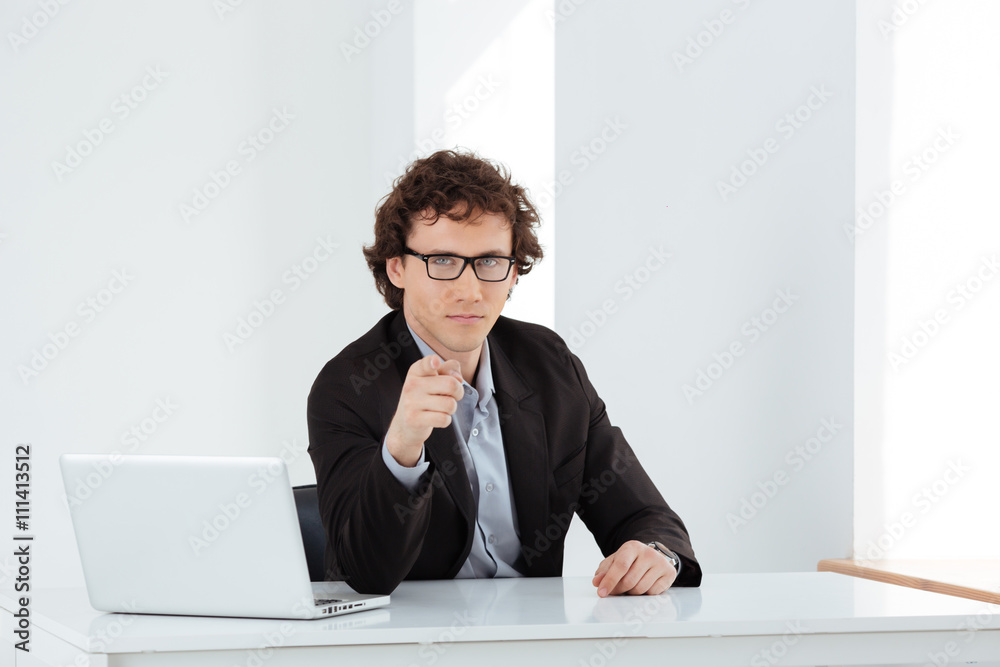 Businessman pointing finger at camera Businessman pointing finger at camera