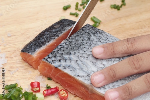 fresh raw salmon fillet on wood background.