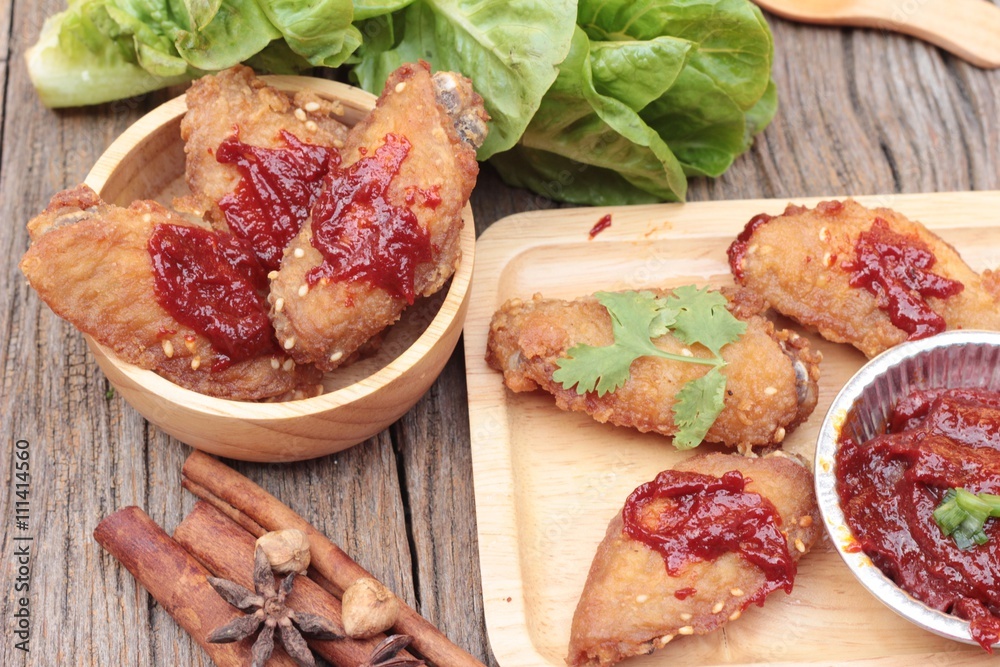 Korean fried chicken is delicious on wood background.