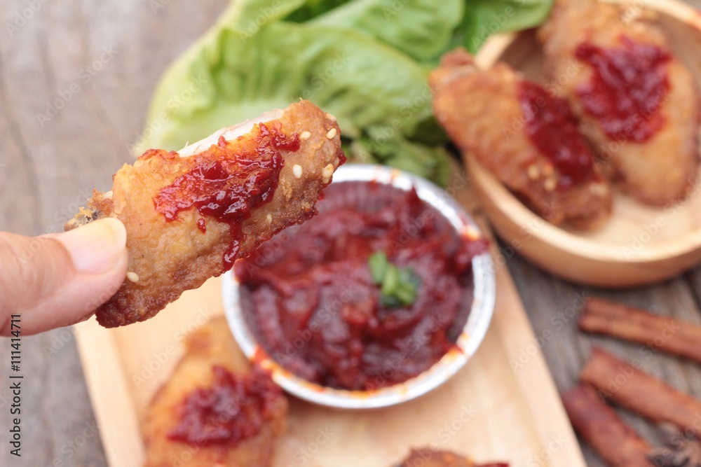 Korean fried chicken is delicious on wood background. Korean fried chicken is delicious on wood background.
