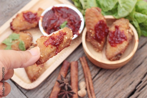 Korean fried chicken is delicious on wood background.