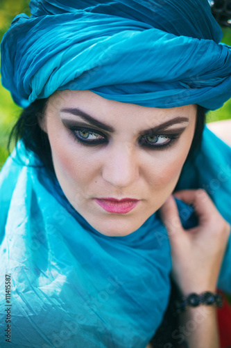 girl in oriental style wearing blue shawl