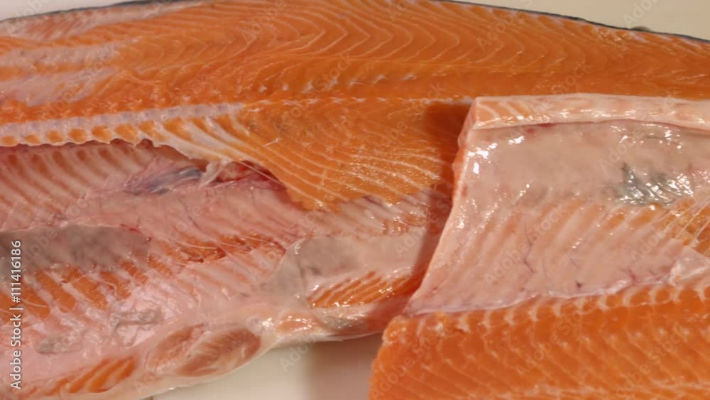 Raw fish with red meat. Fish on white wooden background. It's all muscle tissue. Best salmon for sushi rolls. Raw fish with red meat. Fish on white wooden background. It's all muscle tissue. Best salmon for sushi rolls.