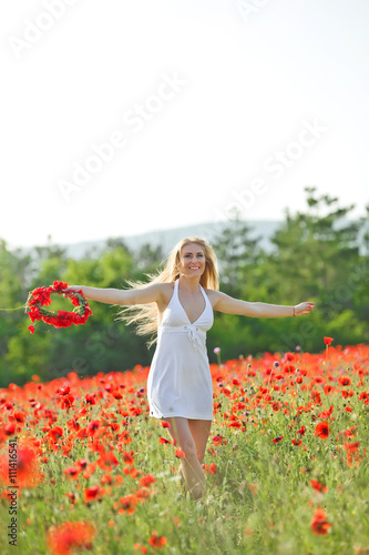 Portrait of beautiful woman in a flowers field
