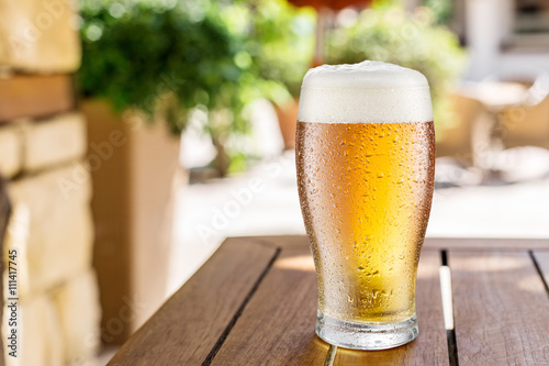 Photography Glass of light beer on the wooden table.