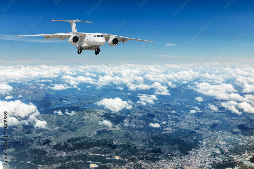 Fototapeta premium Airplane over the clouds.