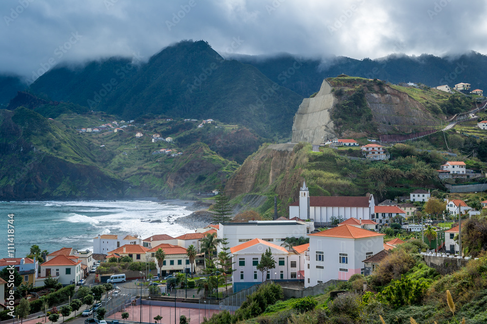Porto da Cruz town surrounded by volcanic rocks and mountains, Madeira island