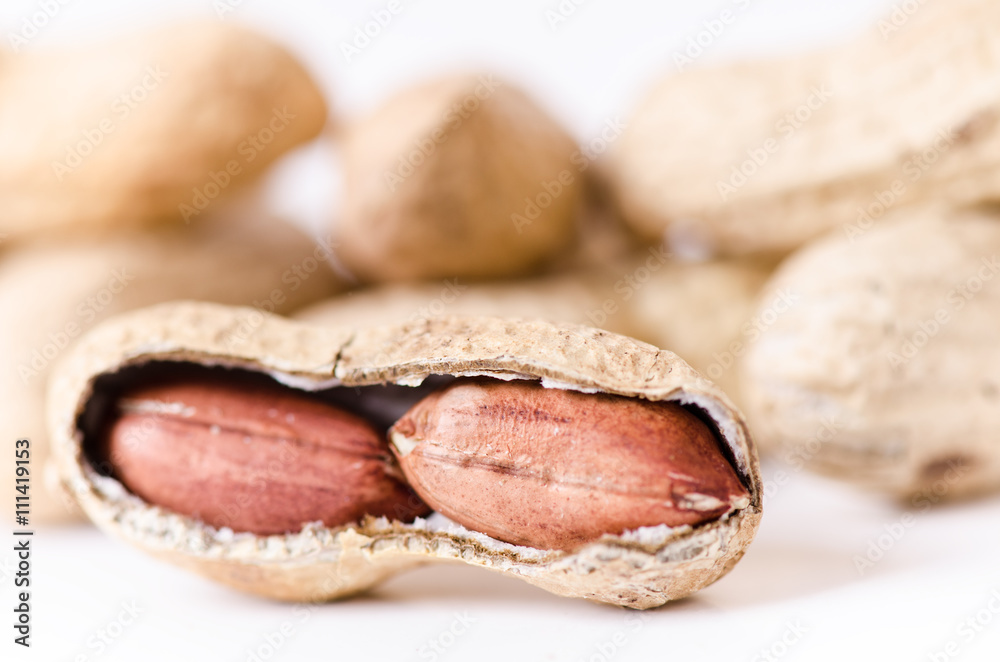Peanuts on a white background. Isolated. Building from nuts. Balance. Open shell. Nutrition. Peanuts butter. Peanuts on a white background. Isolated. Building from nuts. Balance. Open shell. Nutrition. Peanuts butter.