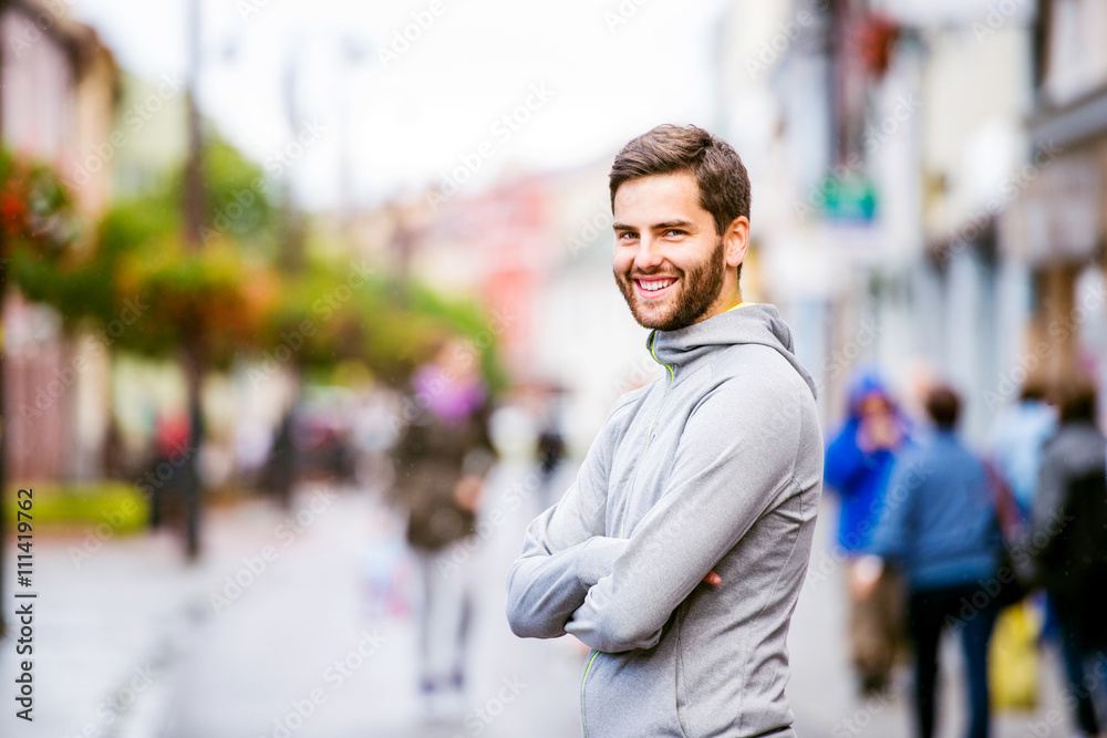 Young hipster man running in town, resting Young hipster man running in town, resting