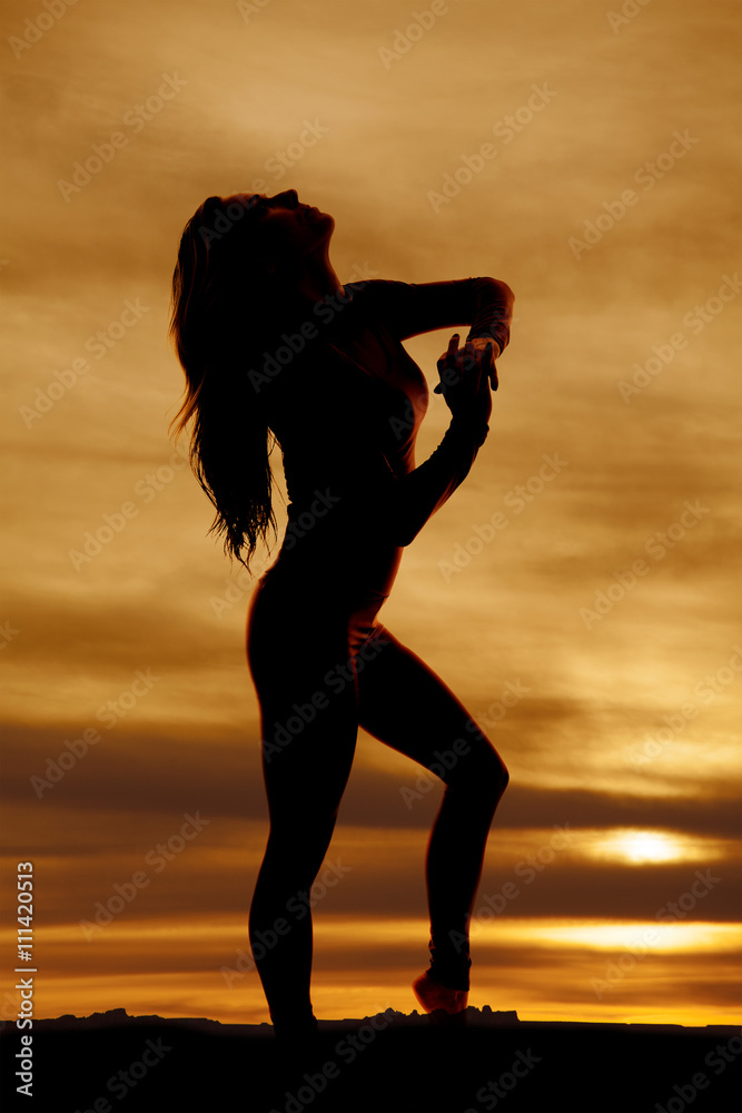 silhouette of a fit woman stand look straight up