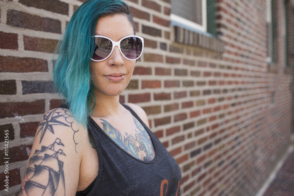 Young woman standing against brick wall Young woman standing against brick wall