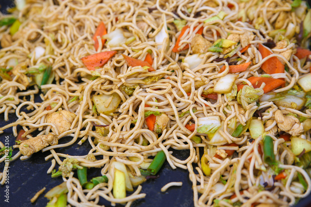 Chinese noodles with beef, muer and vegetables close-up on a plate Chinese noodles with beef, muer and vegetables close-up on a plate