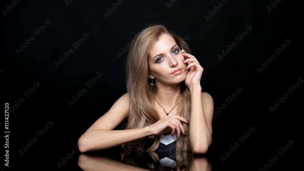 Beauty female video. Blonde woman model posing at mirror table on black background Beauty female video. Blonde woman model posing at mirror table on black background