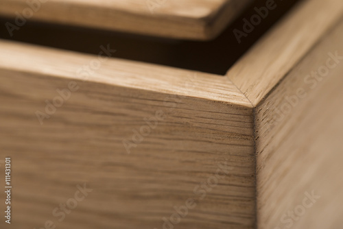 the angle of the wooden box with the lid open, close