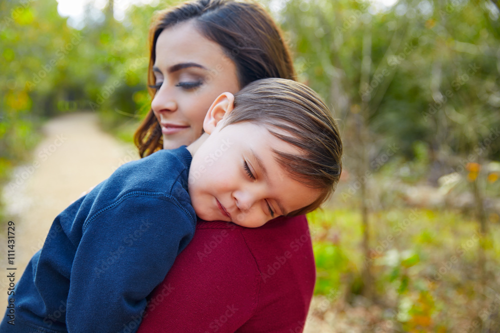 Mother holding kid boy sleeping in her shoulder Mother holding kid boy sleeping in her shoulder