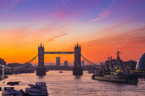 London  England - Tower Bridge and HMS Belfast cruiser at sunrise  