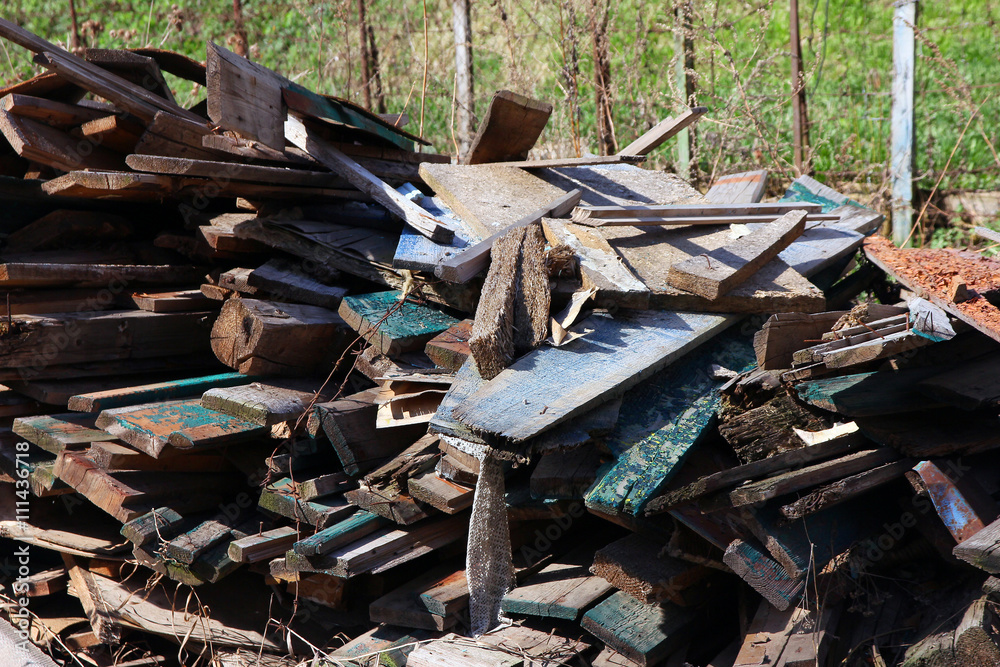A pile of debris and old broken wooden boards after demolition o A pile of debris and old broken wooden boards after demolition o
