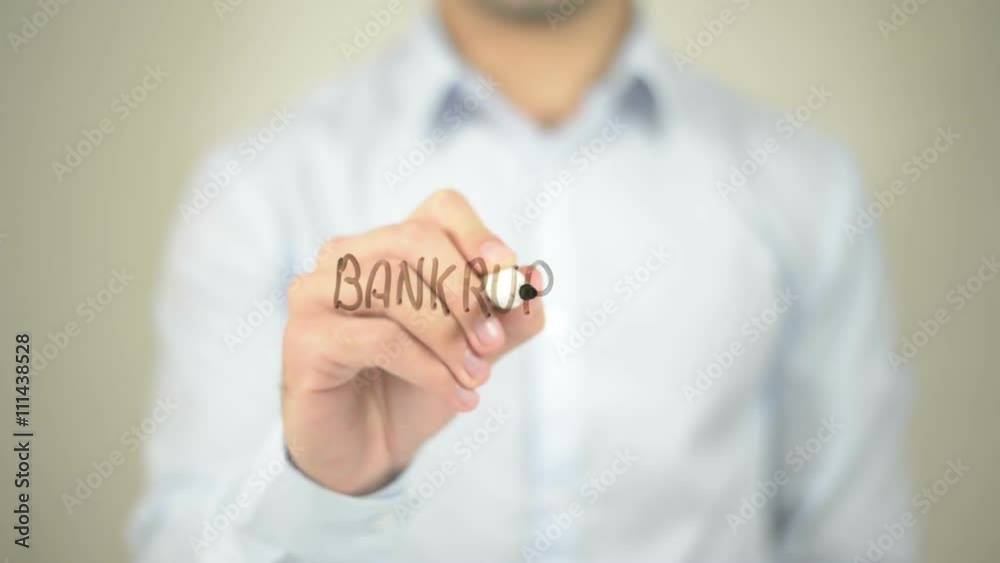 Bankruptcy, Man writing on transparent screen Bankruptcy, Man writing on transparent screen