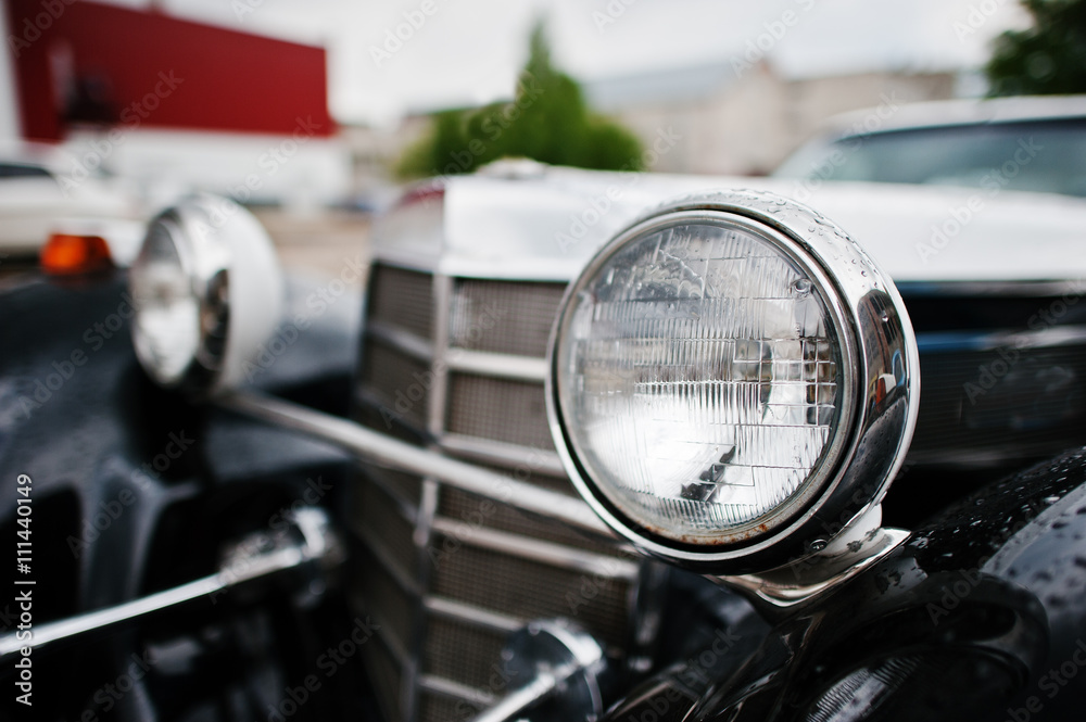 Old vintage car headlight close up.