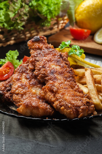 Fried fish in crispy batter with chips