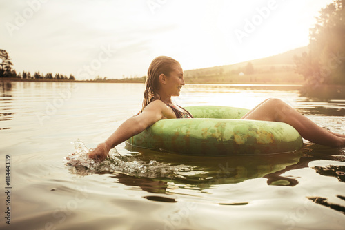 Young woman relaxing in water on a summer day photo