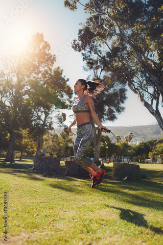 Young woman skipping with a jump rope