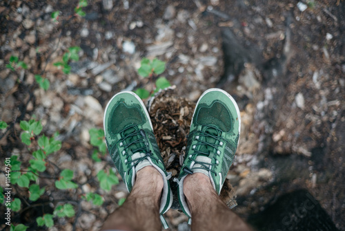 Man hairy legs in forest. Look down. Selective focus