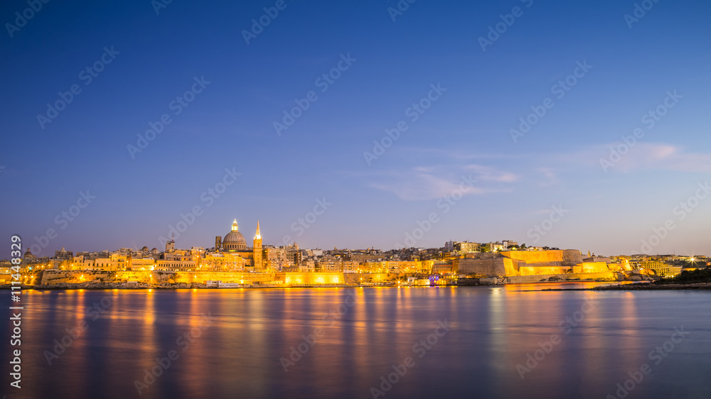 Malta cityscape - The ancient walls of Valletta with St.Paul's Cathedral at magic hour