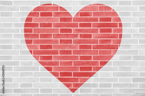 Red heart silhouette on a brick wall